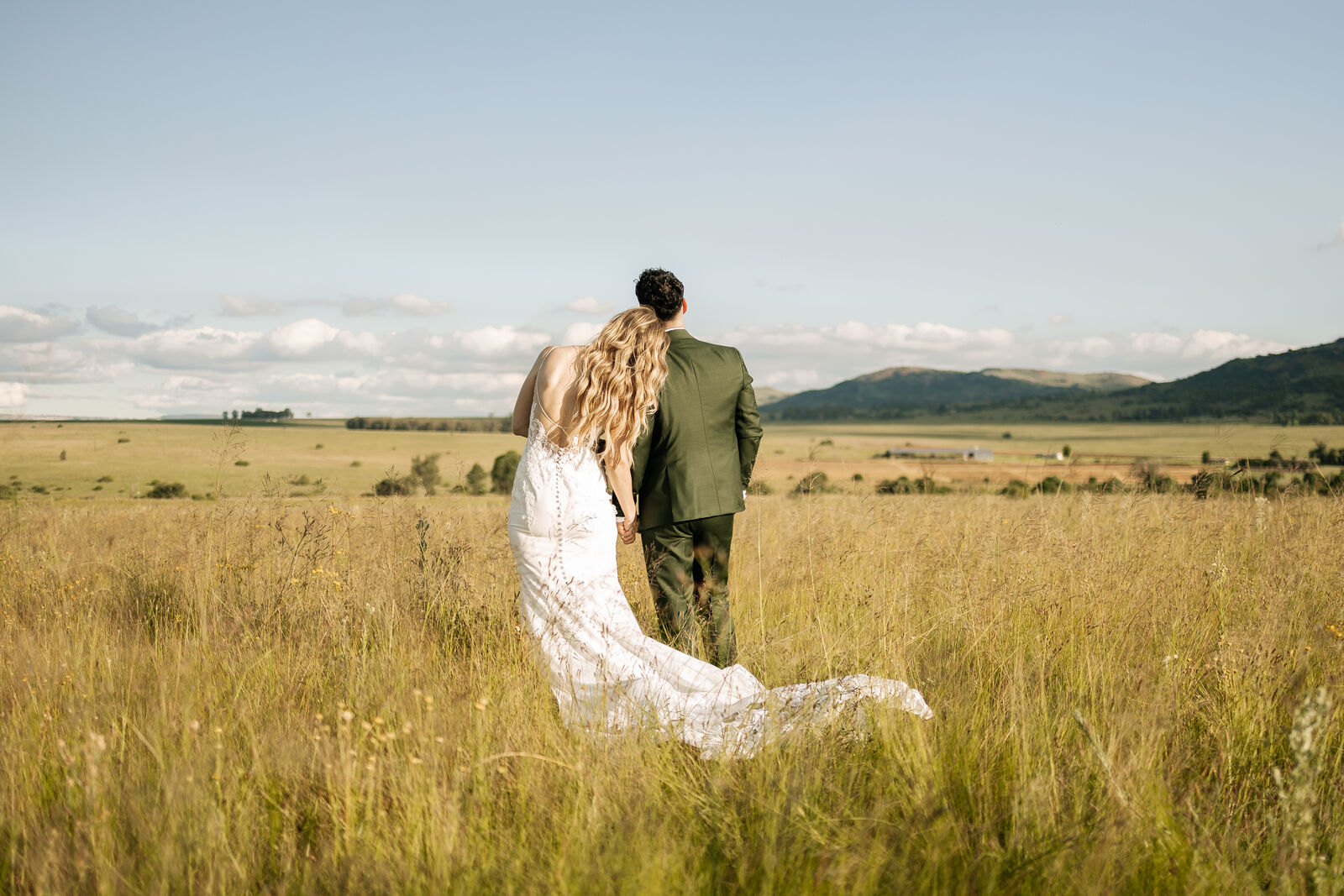 Couple walking into open farmland at The Stone Cellar