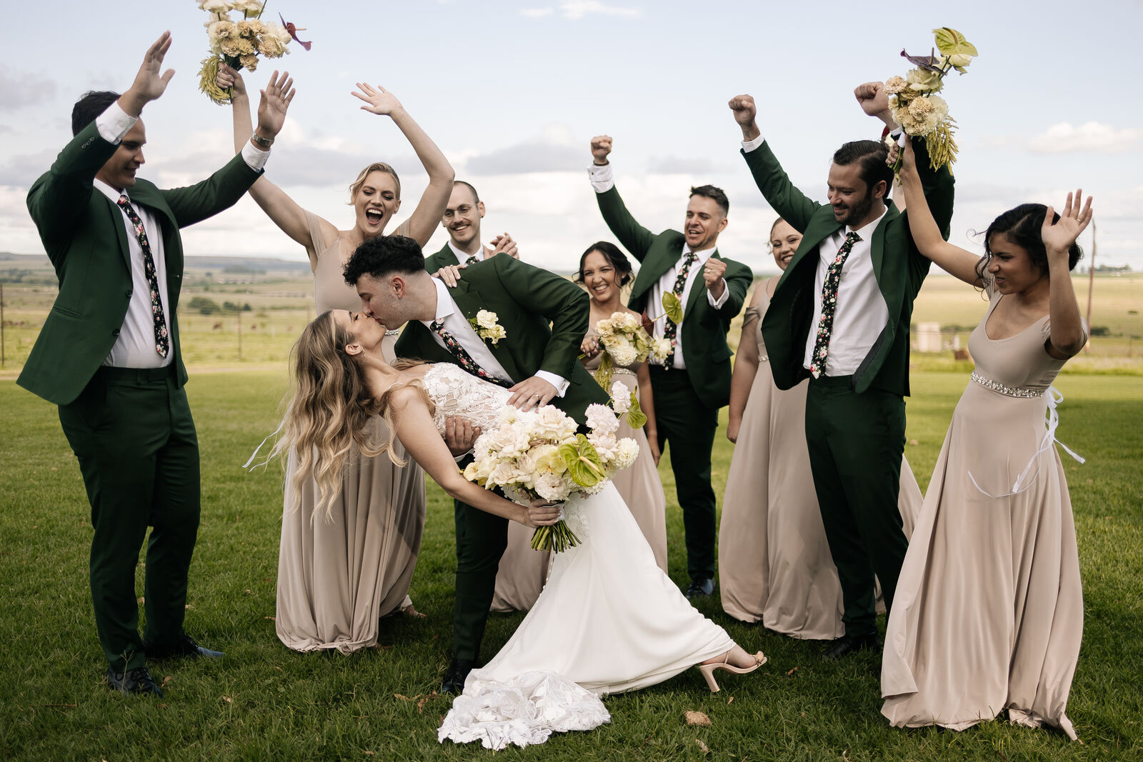 Bridal party celebrating on the farmland at The Stone Cellar